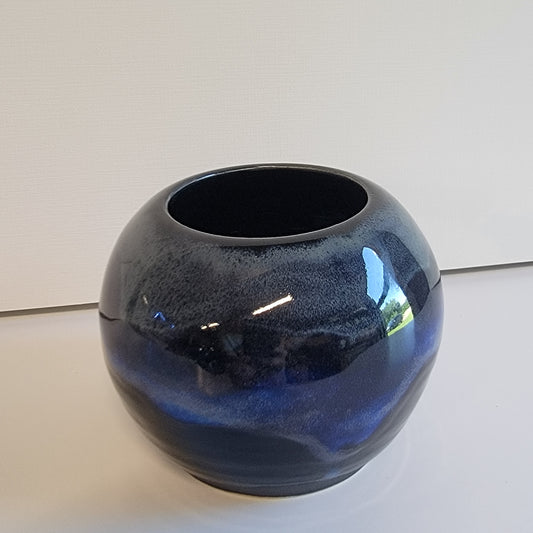 Small round black and blue vase